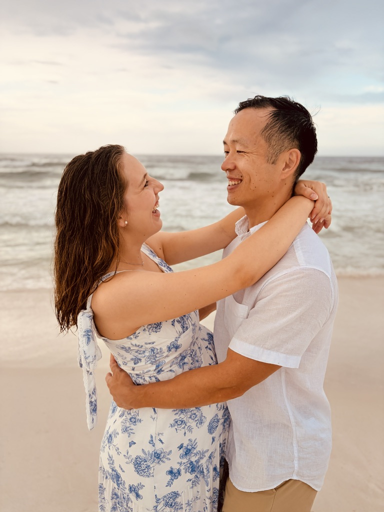 A couple sharing a joyful embrace on the beach